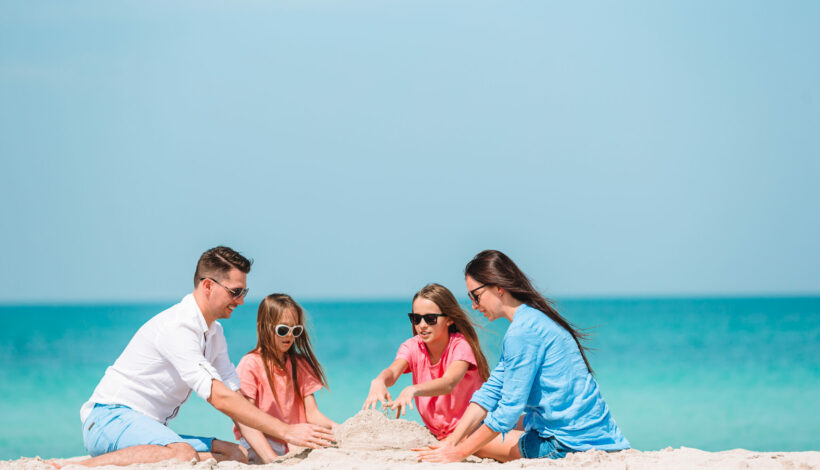 Family of four on the beach vacation